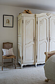 An ornate four-door armoire in the guest bedroom