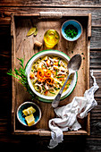 Winter vegetable soup with wild rice on a wooden tray