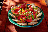 Strawberry and tomato salad with olive oil and crackers