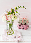 Jar of ranunculus, Easter eggs and egg boxes