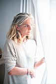 Woman looking through a window