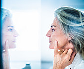 Woman looking at herself in a mirror