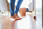 Close up bare feet of woman on hardwood floor