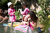 Family relaxing and eating on sunny summer patio