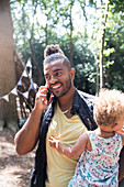 Smiling father holding toddler daughter