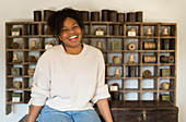 Portrait happy female shop owner at vintage display