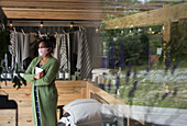 Thoughtful female shop owner in face mask looking away