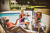 Senior women friends drinking champagne and sunbathing