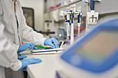 Scientists in rubber gloves using equipment in laboratory