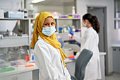 Portrait confident scientist in hijab and face mask
