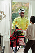 Woman receiving pizza delivery from delivery man