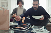 Couple enjoying egg roll takeout food with chopsticks