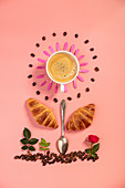 Creative layout made of croissants, coffee, spoon and flowers