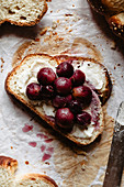 Sliced challah with butter and pickled grapes