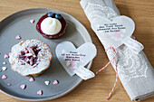 Stitched hearts made of tracing paper with confetti inside and mottos
