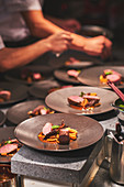 Chefs preparing dishes in French restaurant
