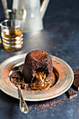 Chocolate lava cake with caramel dusted with cocoa