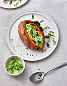 Baked sweet potato with pea and goat’s cheese dip