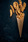 Fluted rustic potato pieces in paper cone