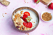 Bowl of yoghurt and granola with strawberries