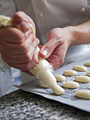 Piping batter for macarons onto baking paper