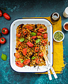Baked beans and chickpeas with peppers, tomatoes and herbs