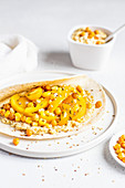 Yellow humus wrap with corn and pepper