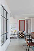 Dining area with various chairs in open-plan interior