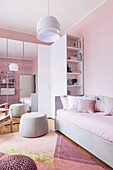 Sofa bed, shelf and wardrobe with mirrored doors in girl's bedroom