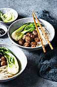 Meatballs with noodles and pak choi