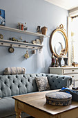 Chesterfield sofa against pale blue wall in vintage-style living room