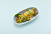 Courgette spaghetti with tomatoes and hemp seeds