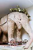 Vintage-style arrangement with old toy elephant on wheels