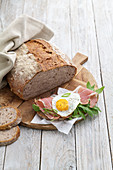 Potato bread with rocket, ham and a fried egg