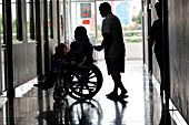 Child in wheelchair in hospital corridor
