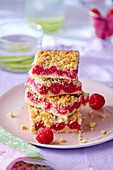 Several pieces of raspberry crumble cake, stacked