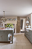 Custom cabinets with light grey fronts in country-house-style kitchen