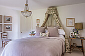 Romantic bedroom with chandelier and canopy add a touch of glamour