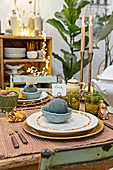 Dining table festively decorated with balls, candles and fairy lights