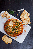 Coulommier cheese ball with garlic, paprika and peanuts
