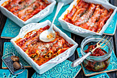 Cannelloni with quark, spinach and dried tomatoes, baked in tomato sauce