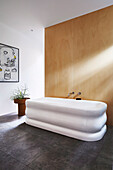 Corrugated bathtub in minimalist bathroom