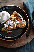 A slice of apple tart with a dollop of cream