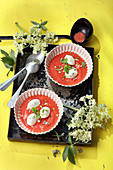 Iced elderberry and strawberry soup with tonka yoghurt dumplings