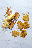 Rosti and raw potatoes on a vegetable grater