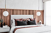 Halbhoch mit Holz verkleidete Wand im eleganten Schlafzimmer