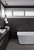 Marble tiles in modern, masculine bathroom decorated in black and grey