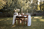 Festively set table in late summer garden