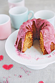 A mini ginger Bundt cake with pink icing