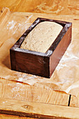 Sourdough bread in a wooden baking frame